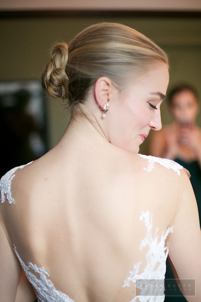 Bride in wedding gown and makeup open back