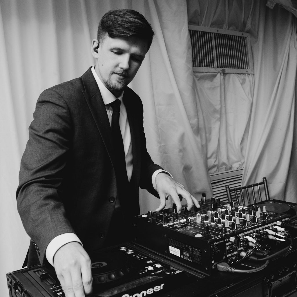 dj coolhand in action, mixer and gear in wedding tent