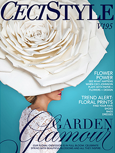 Ceci Johnson posing on the cover of her magazine in enormous paper hat and strong lipstick