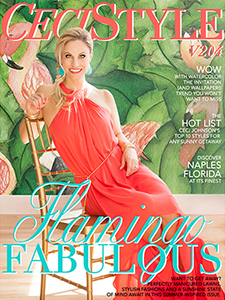 Ceci Johnson posing in bright coral with bronzy makeup on the cover of her magazine