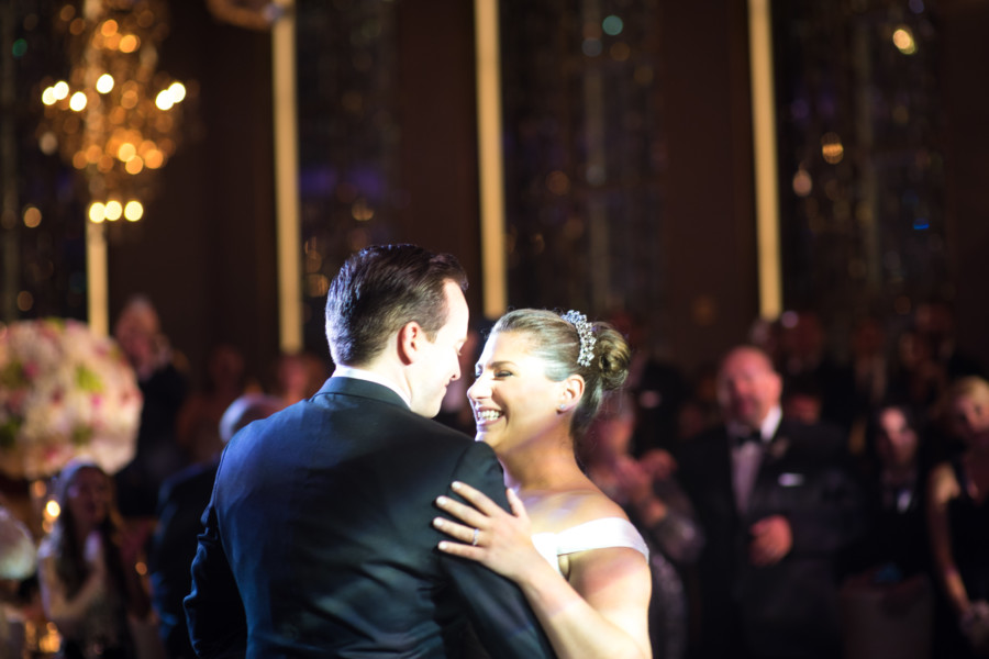 Modern bride with classic updo and tiara and groom dancing at the Rainbow Room in New York City