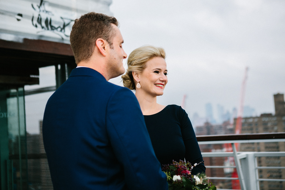 Blonde bride with chic updo and red lips at her elopement in the Lower East Side of New York City