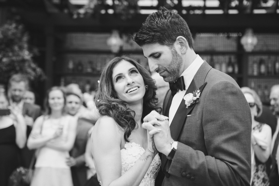 Black and white image of bride with long wavy hair and dramatic makeup dancing with groom at Gramercy Park Hotel in New York City