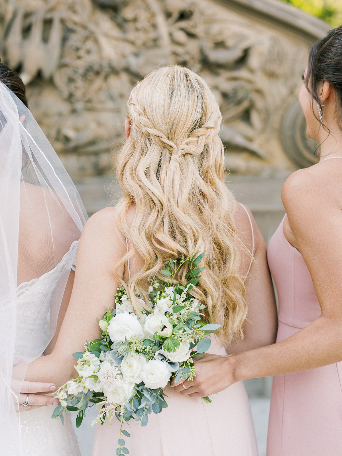 Bridesmaid with blonde hair styled with waves and cool braid detail