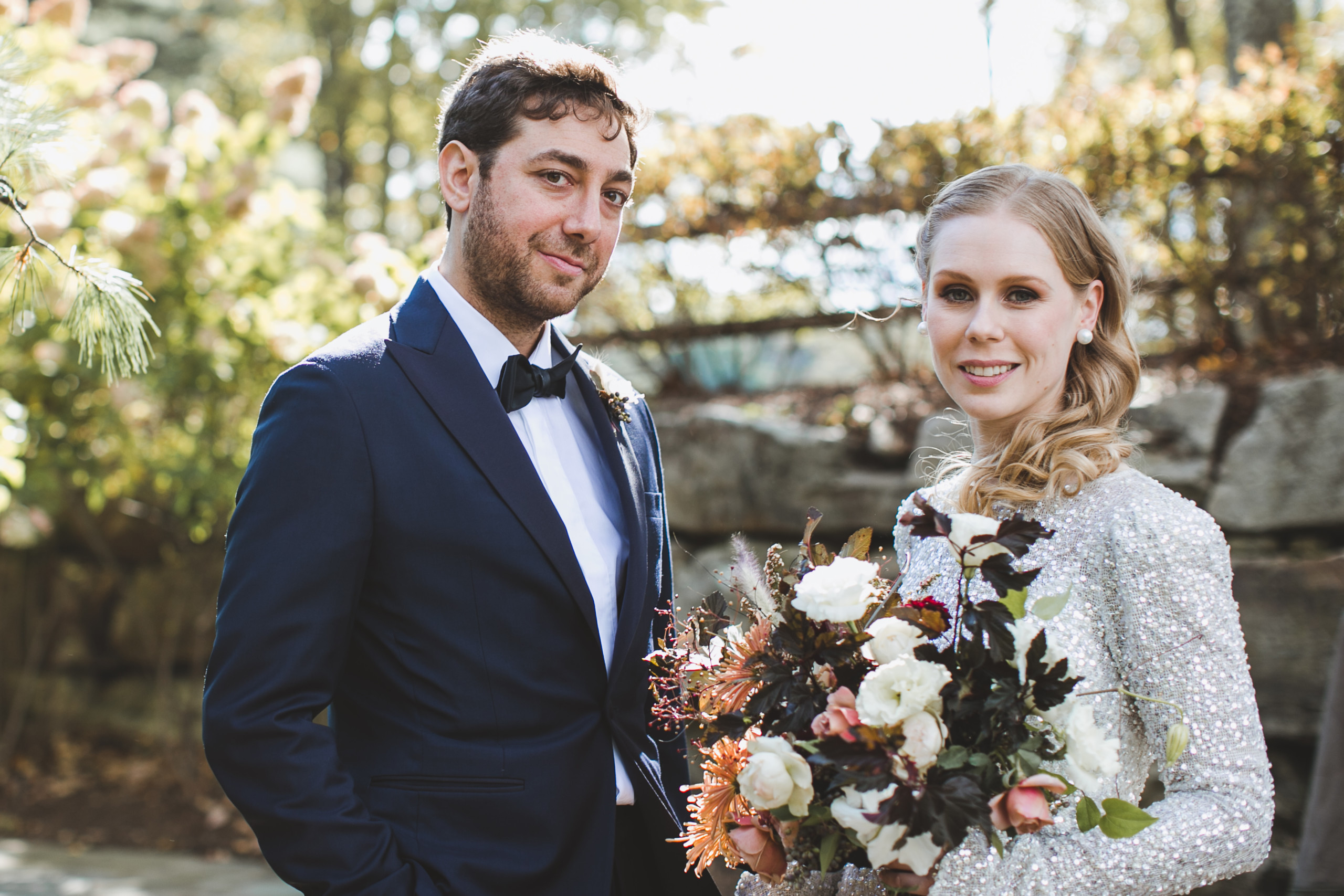 Blonde bride with hair styled in Hollywood waves greets her groom at Cedar Lakes Estate