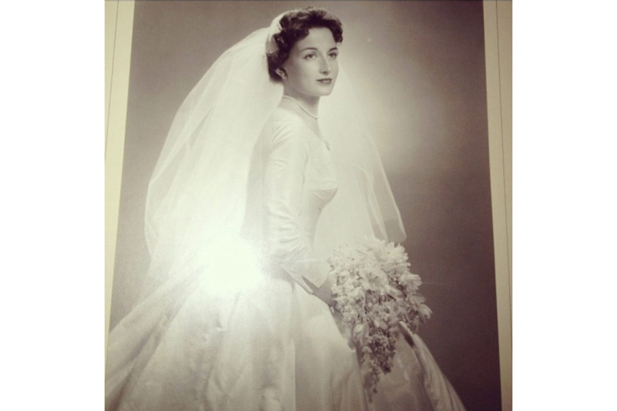 Black and white bridal portrait, Sharon's mother with wavy dark hair, 3/4 angle. Long veil, full skirt, big bouquet.
